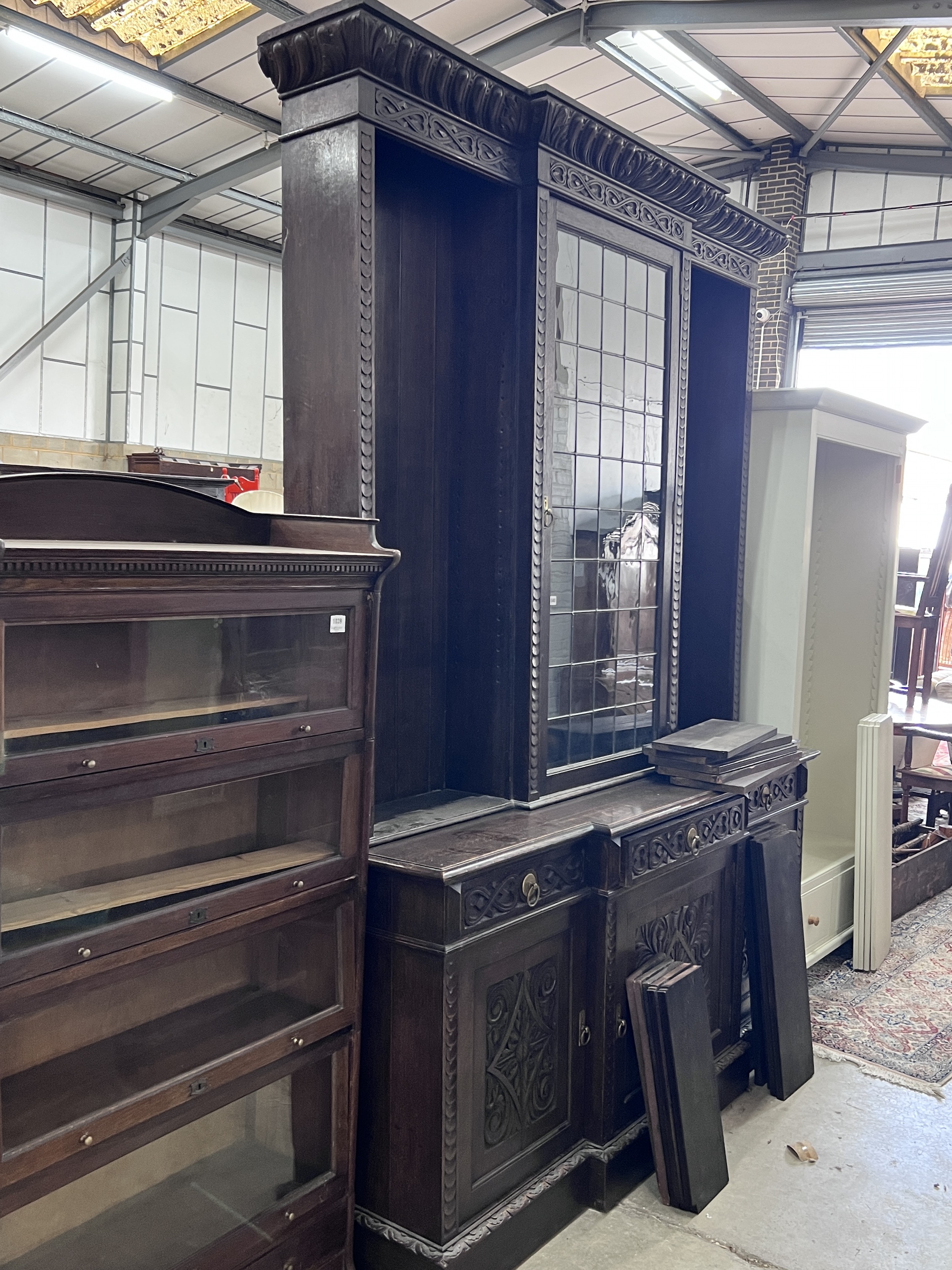 An early 20th century carved oak breakfront library bookcase, width 206cm, depth 54cm, height 260cm